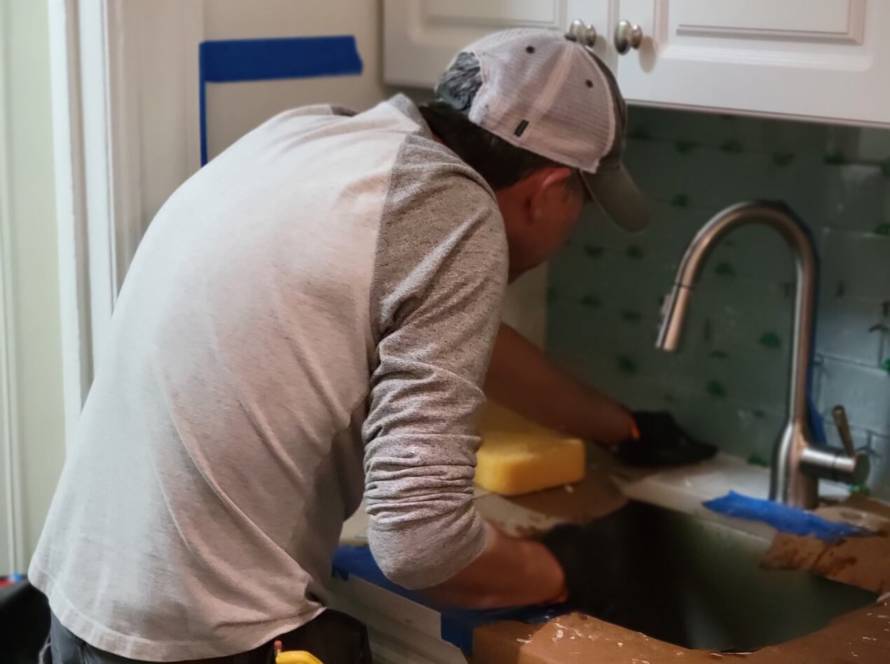 man preparing to install new kitchen tiles